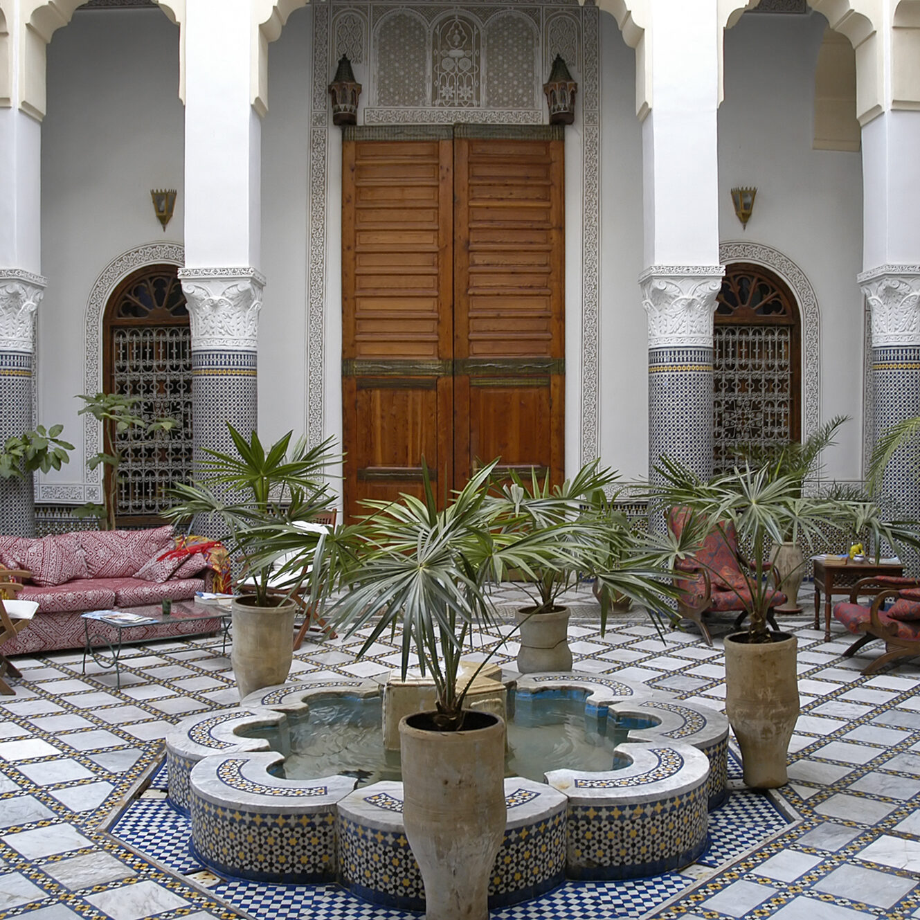 "Courtyard in old riad (traditional Moroccan house or palace) in Fez, Morocco with fountain"